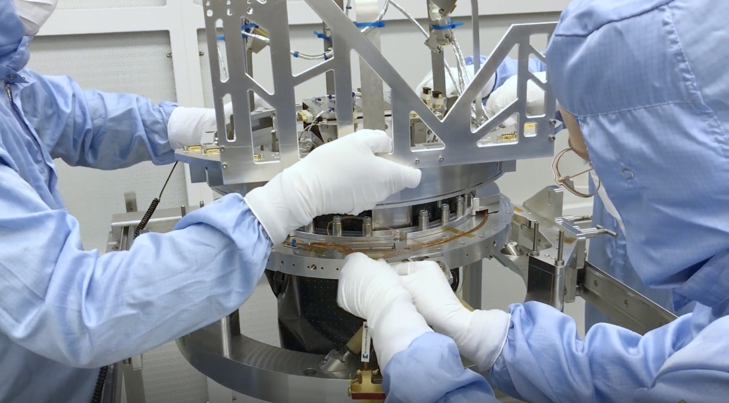 People working in SRONS cleanroom on a space camera. This is to illustrate the kind of cleanroom a candidate technical employee will work on, when applying for this vacancy.